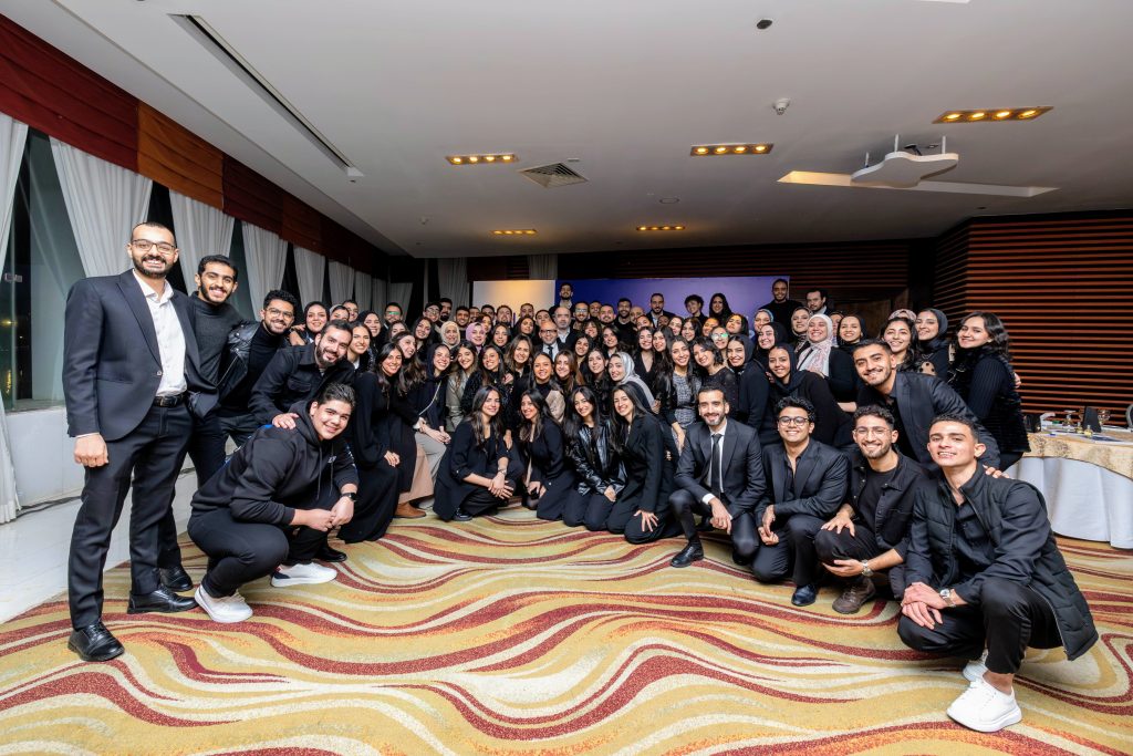 A group photo of the entire Pimula team at the annual meeting, dressed in all black, celebrating a decade of innovation and success.